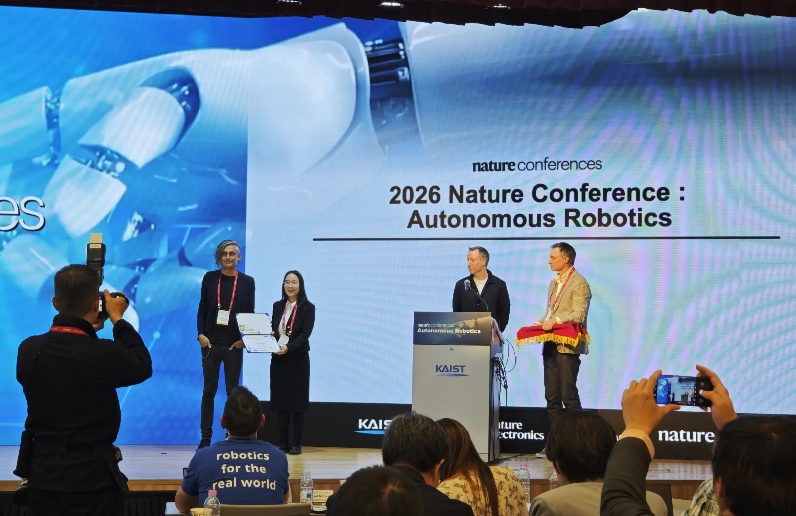 Benwang Chen receiving first place in the poster presentation at the Nature Conference on Autonomous Robotics