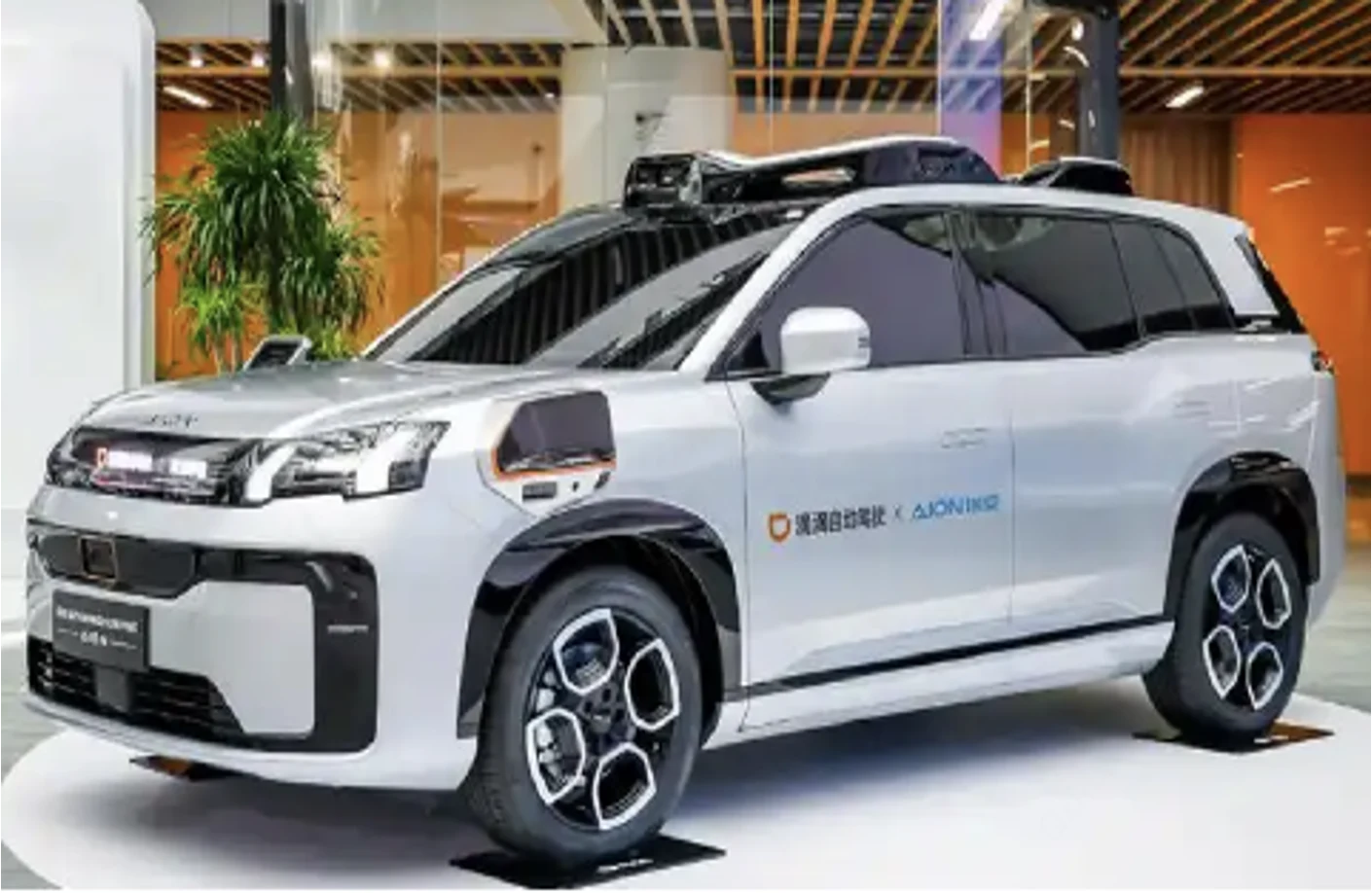 White autonomous vehicle with roof-mounted sensors