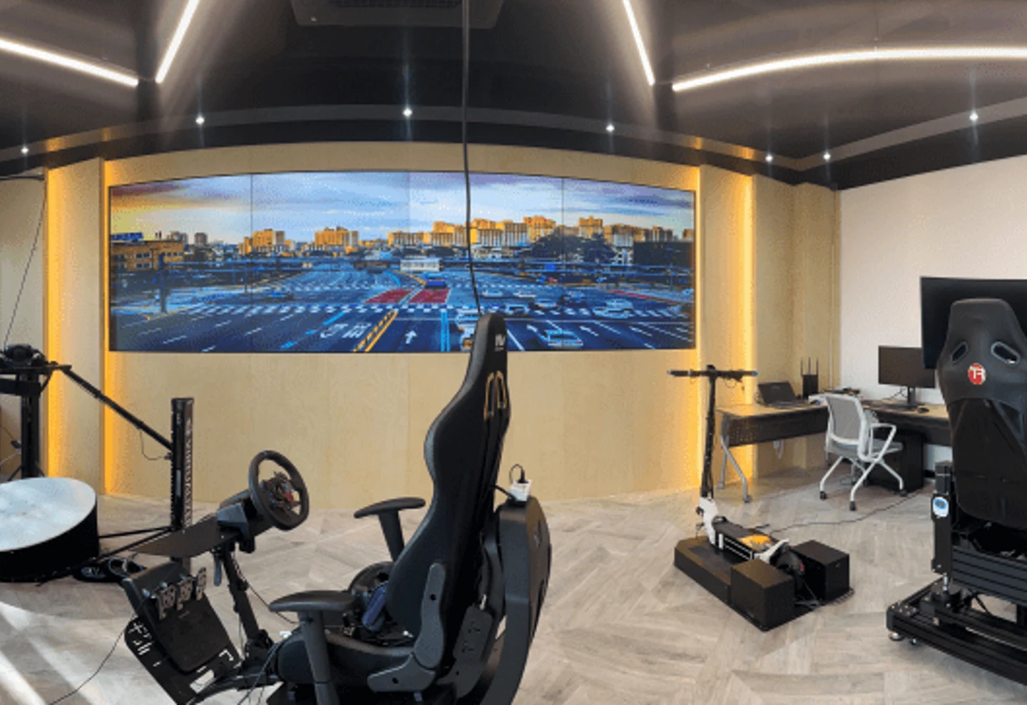 Driving simulator with cockpit controls and a wide display